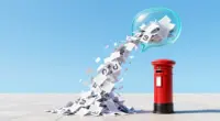 A red British post box on a bright plaza, with a stream of paper letters pouring out of a glowing glass chat bubble and piling up around it