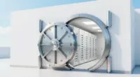 A large round steel vault door standing open in a bright white wall, revealing rows of white server racks inside a clean, well-lit room