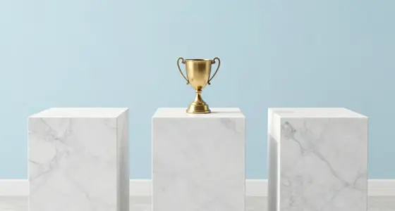 Three white marble pedestals of almost equal height in a bright gallery, a small brass trophy on the middle one